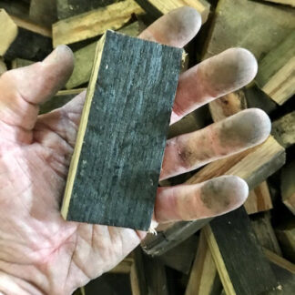 bourbon barrel smoking chunks in hand